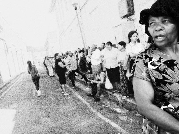 A black and white photograph from the Civil Rights Movement era, showing a group of African American protestors marching for voting rights. They are holding signs and banners advocating for equal access to the ballot box, capturing the historical struggle for voting rights in the United States.