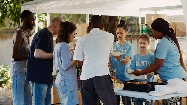 A group of volunteers at a community event, handing out campaign flyers and speaking with attendees about the candidate's platform.