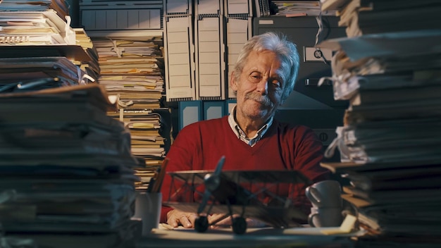 An image showing a focused small business owner meticulously reviewing a stack of documents labeled 
