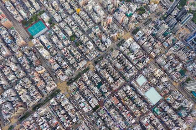 An aerial view of a densely populated urban area with apartment buildings and rental properties. The image illustrates the importance of affordable housing and the impact of federal policies on renters.