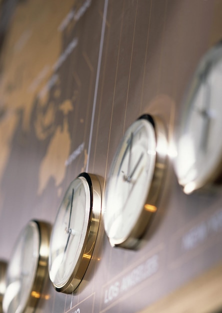 A close-up of a digital time clock with hands moving rapidly, overlaid with calculator symbols, suggesting the calculation of wages and overtime.