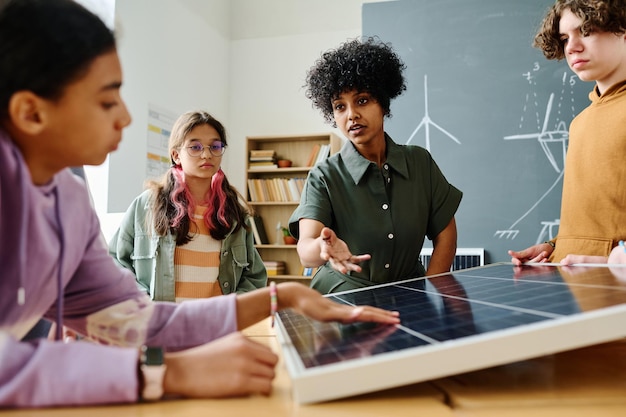 A group of students in a classroom learning about solar panel installation, demonstrating workforce development programs.