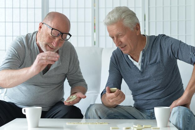 A split image. On one side, a worried senior looking at medical bills. On the other side, a relaxed senior smiling while holding a Medicare card, symbolizing financial relief.