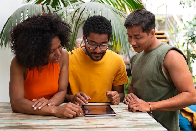 A diverse group of people looking at a tablet that displays information about ACA subsidies. Graphs and charts are visible, indicating the potential financial benefits. The setting is a community center, symbolizing accessible healthcare information.