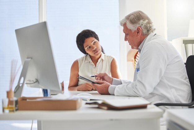 A doctor consulting with a patient in an office, emphasizing the importance of having access to trusted healthcare providers through your insurance plan.