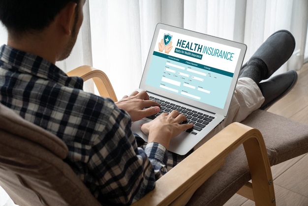 A person sitting at a computer, filling out an online application form for ACA subsidies on the HealthCare.gov website. They are focused and carefully entering their information.