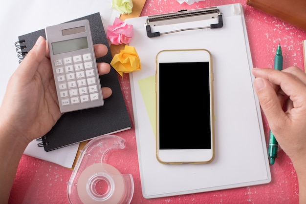 A person organizing receipts and bills, with a calculator and a SNAP application form nearby, symbolizing careful financial planning and deduction management.