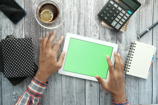 A person looking at a calculator with the SSI logo in the background. They appear to be completing their financials and researching if they qualify for SSI benefits.