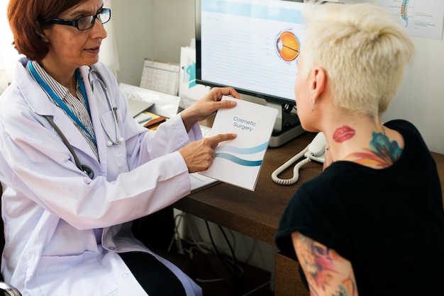 A doctor reviewing medical records with a patient, emphasizing the importance of medical evidence in a disability claim.