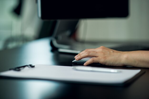 A close-up shot of hands typing on a keyboard, focused on the act of filling out an online application for unemployment benefits.