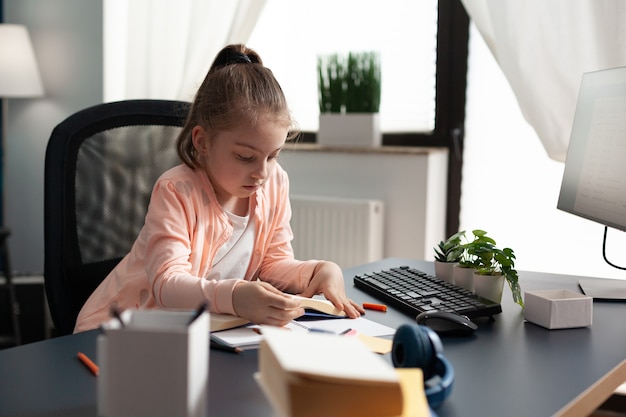 A child is sitting at a desk, working on homework with the help of a supportive caregiver, surrounded by educational materials. This image depicts how SSI can enable better learning support for children with disabilities.