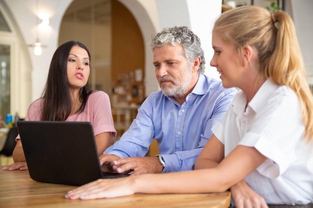 A Social Security Administration representative is shown assisting a family with the application process in a clean and professional office environment.