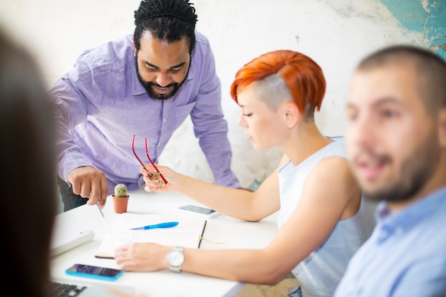 A group of people participating in a job training workshop at a CAA. They are engaged in a hands-on activity, with the instructor providing guidance. The atmosphere is collaborative and supportive.