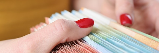 A close-up of hands carefully organizing and compiling various documents such as pay stubs, bank statements, medical records, and letters, illustrating the importance of thorough documentation for an appeal.