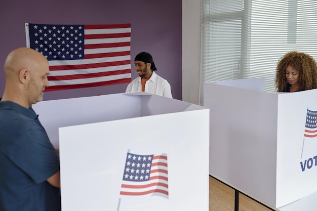 A split image showing voters casting ballots in person at a polling station on one side and mailing in their absentee ballots on the other, illustrating the different ways people can participate in the election.