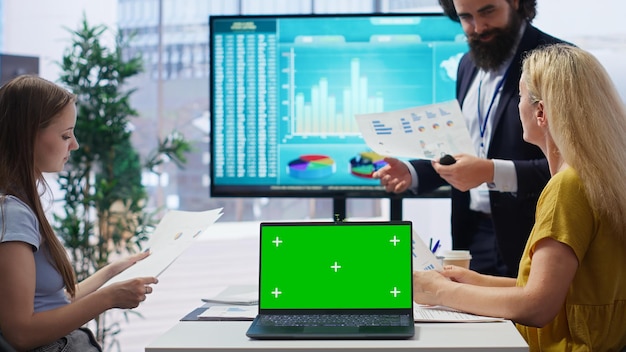 A person reviewing investment charts and graphs on a computer screen, analyzing HSA investment performance, showcasing active financial management.