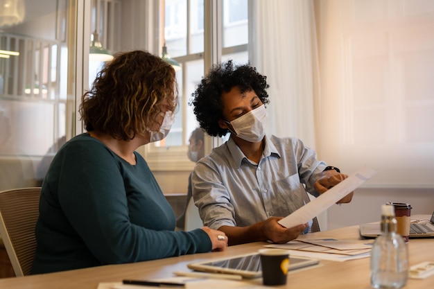 A caseworker sitting at a desk, explaining TANF work requirements and exemptions to a client with a warm and supportive demeanor.
