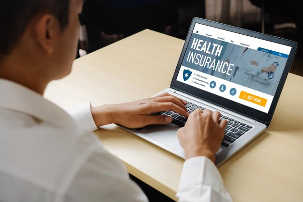 A person sitting at a desk, reviewing health insurance options on a laptop. The image captures the individual navigating the Health Insurance Marketplace website, comparing plans and benefits.