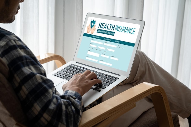 A person sitting at a computer, looking at a healthcare marketplace website, with various health insurance plans displayed. They appear focused and engaged, researching their options.
