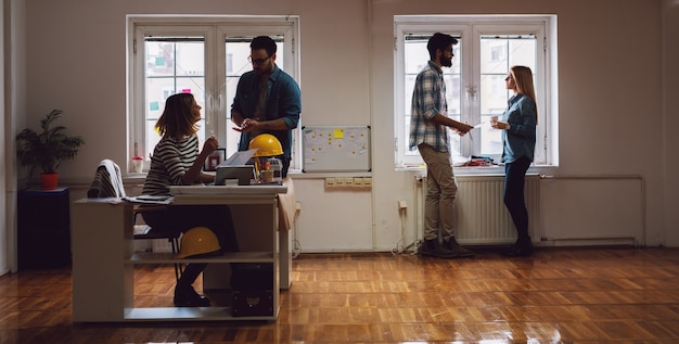 A busy public housing agency office with people waiting in line and staff assisting them at the desks. The image represents the real-world setting of housing assistance services.